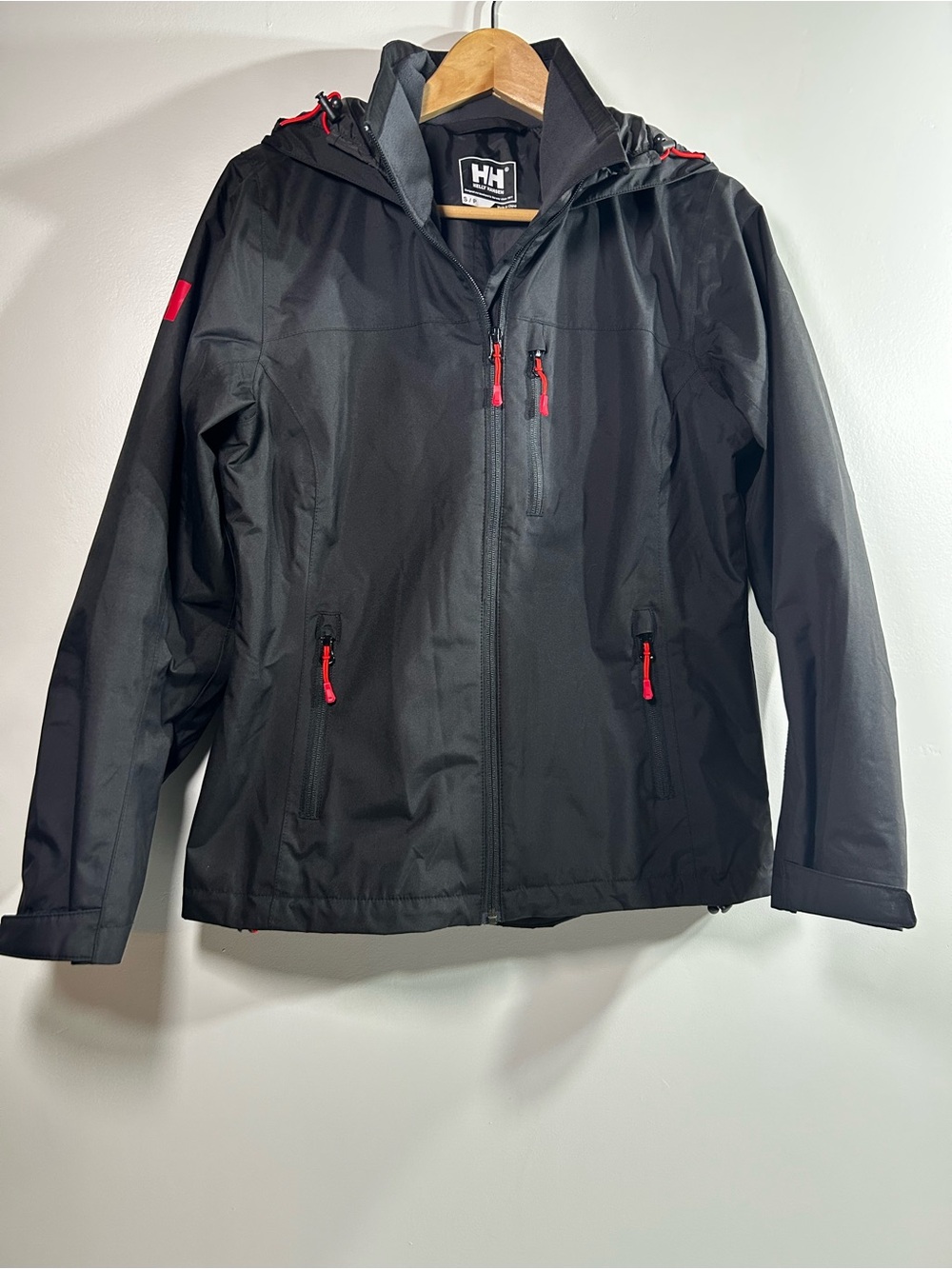 Helly Hansen women’s Black Raincoat with Red Zipper Accents